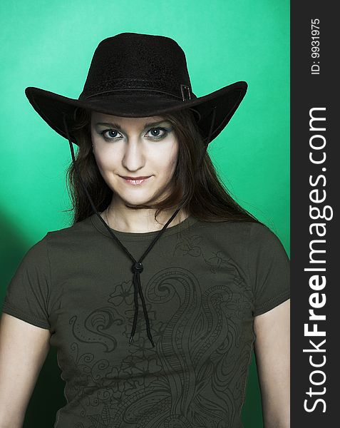 Portrait of young woman in dark cowboy hat. Portrait of young woman in dark cowboy hat