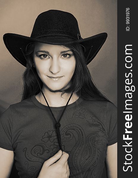 Portrait of young woman in dark cowboy hat. Portrait of young woman in dark cowboy hat