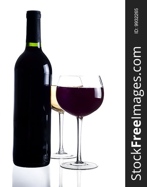 A bottle of red wine, glass of red wine and glass of white wine