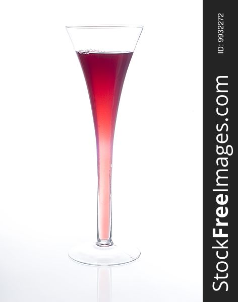 Long glass of red beverage