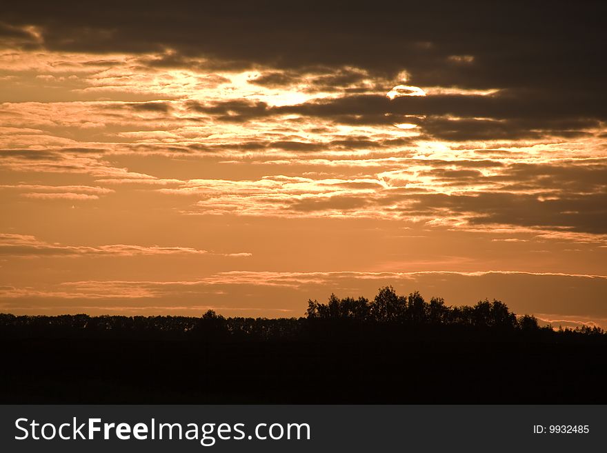 Sunset on cloudy sky. Landscape in pink colors