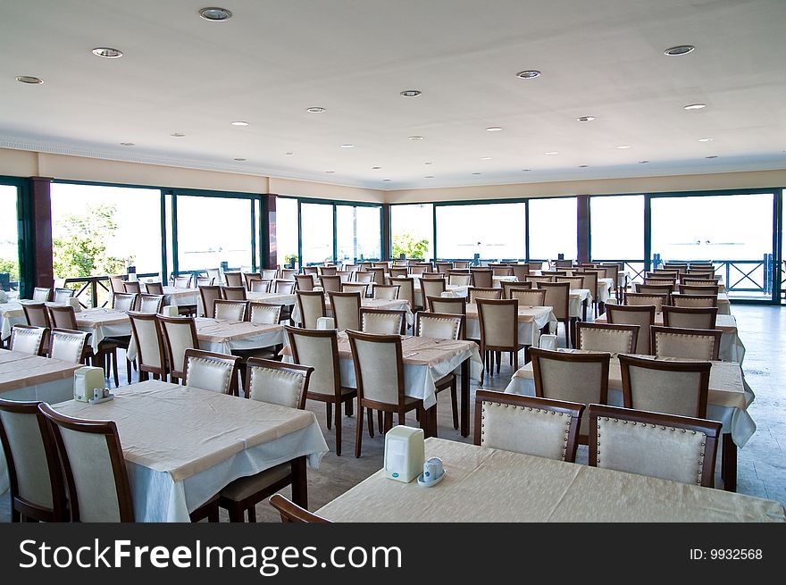 Empty cafe with tablecloth on a tables