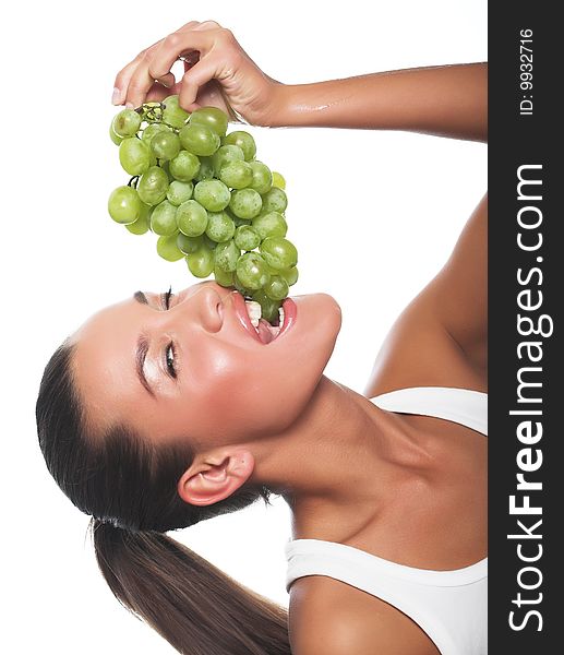 Beautiful young woman with green grape