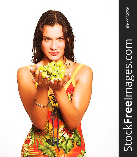 Portrait of young attractive woman with bunch of grapes