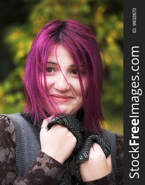 Close-up portrait of a young woman during her walk in a park. Close-up portrait of a young woman during her walk in a park