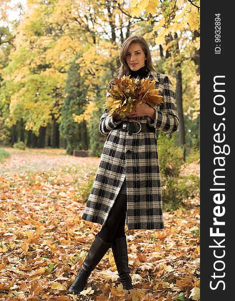 Young woman in autumnal park