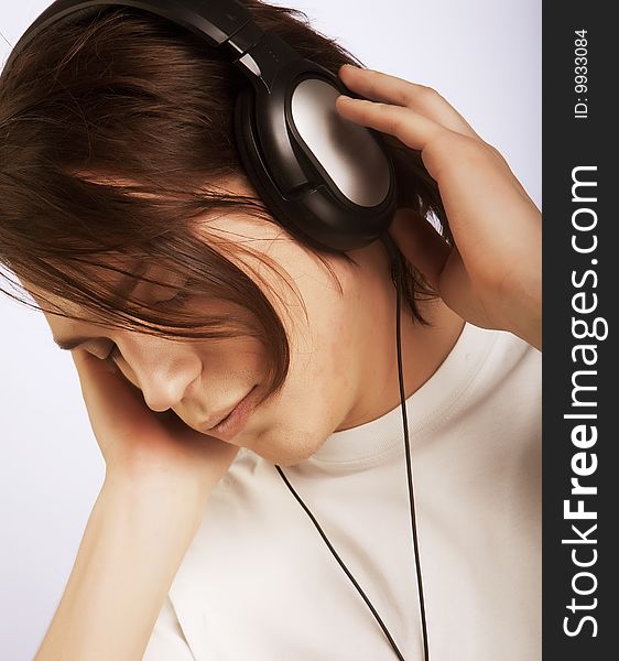 Casual man listening to music, isolated in white background