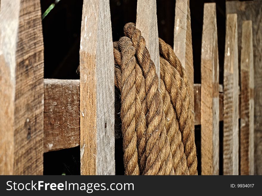 This image was captured on a local horse farm. The fence post in the foreground has a rope wrapped near the top. This image was captured on a local horse farm. The fence post in the foreground has a rope wrapped near the top.