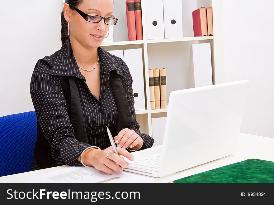 Beautiful business woman in office with glasses. Beautiful business woman in office with glasses