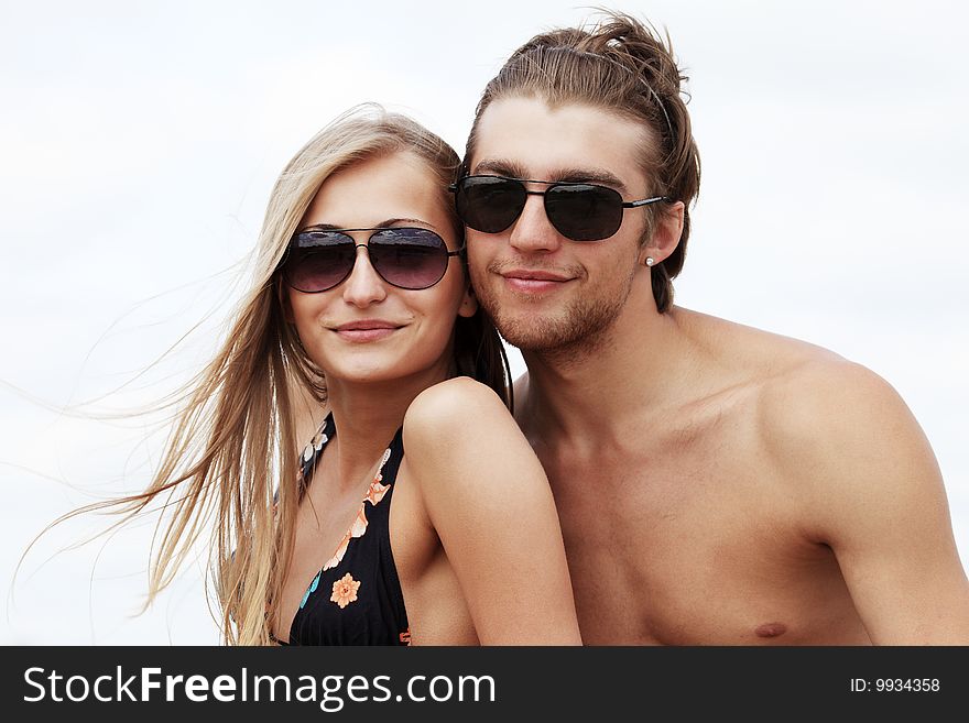 Couple of young people having a rest on a beach. Great summer holidays. Couple of young people having a rest on a beach. Great summer holidays.