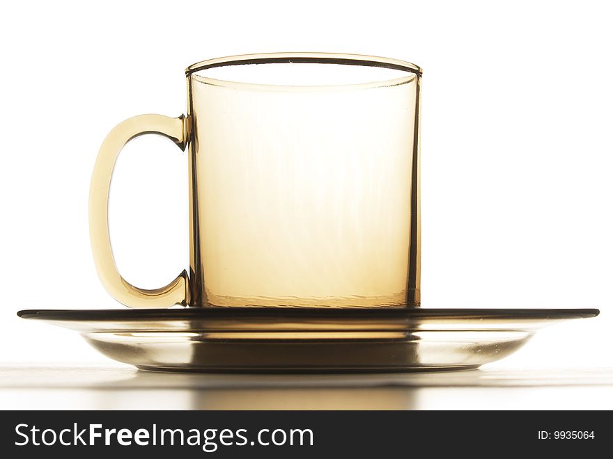 Empty cup and plate brown glass isolated on white. Empty cup and plate brown glass isolated on white