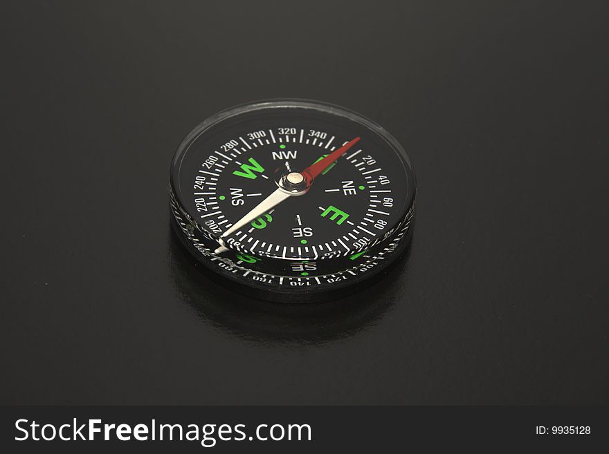 The Black background and traditional black compass. Concept the pirate, a piracy.