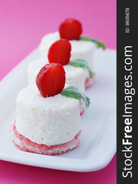 Curd Tenderness On Air Biscuits With A Strawberry