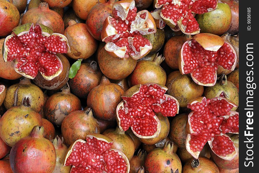 Closeup of pomegranate seeds and fruit (Punica granatum) on display in a street market