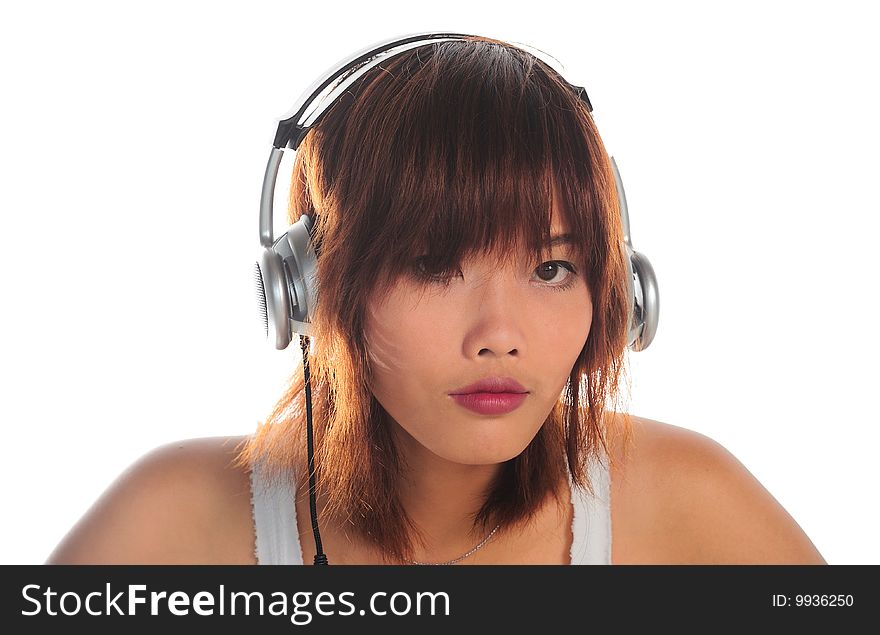 Very seductive young asian woman listening music with headphone