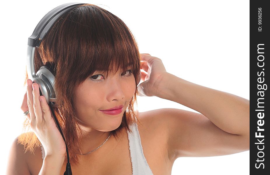 Very seductive young asian woman listening music with headphone