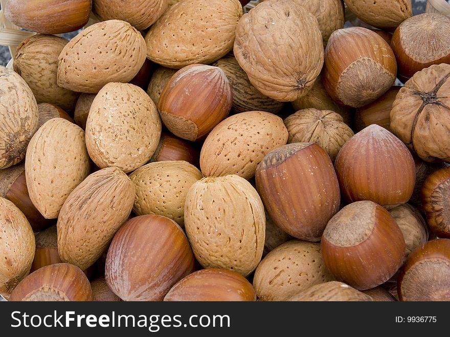 Background consisting of various nuts full bowl.