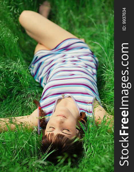 Young girl lying in grass