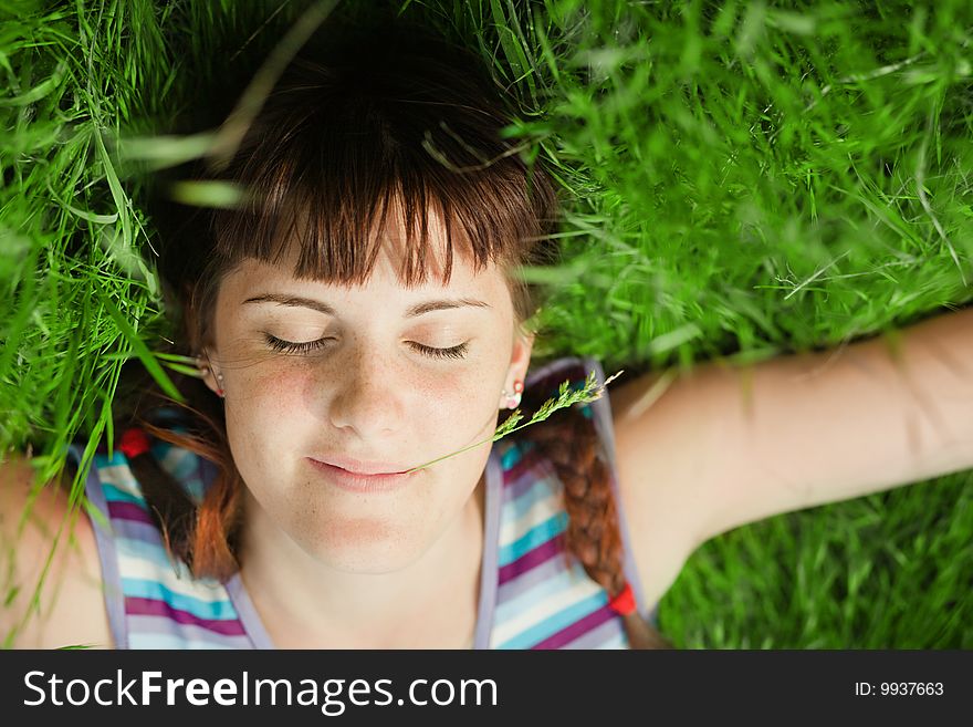 Young girl lying in the grass