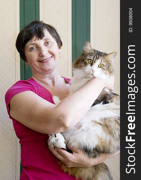 Aged woman carrying a cat. Aged woman carrying a cat