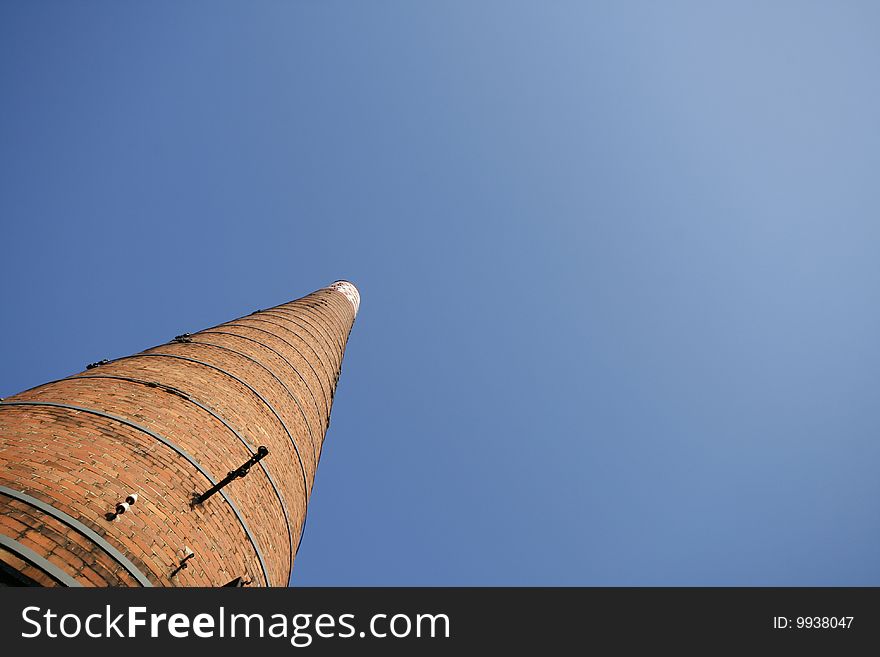 Chimney of the paper mill in Upper Silesia - industrial district in Poland. Abstract and original frame.