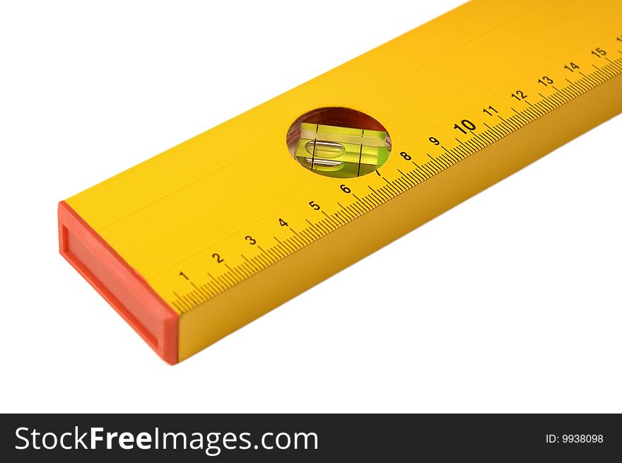 Part of a yellow ruler with level on a white background