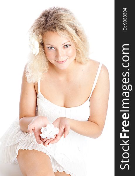 Beautiful smiling girl in white dress lying on floor. Isolated on white background. Beautiful smiling girl in white dress lying on floor. Isolated on white background