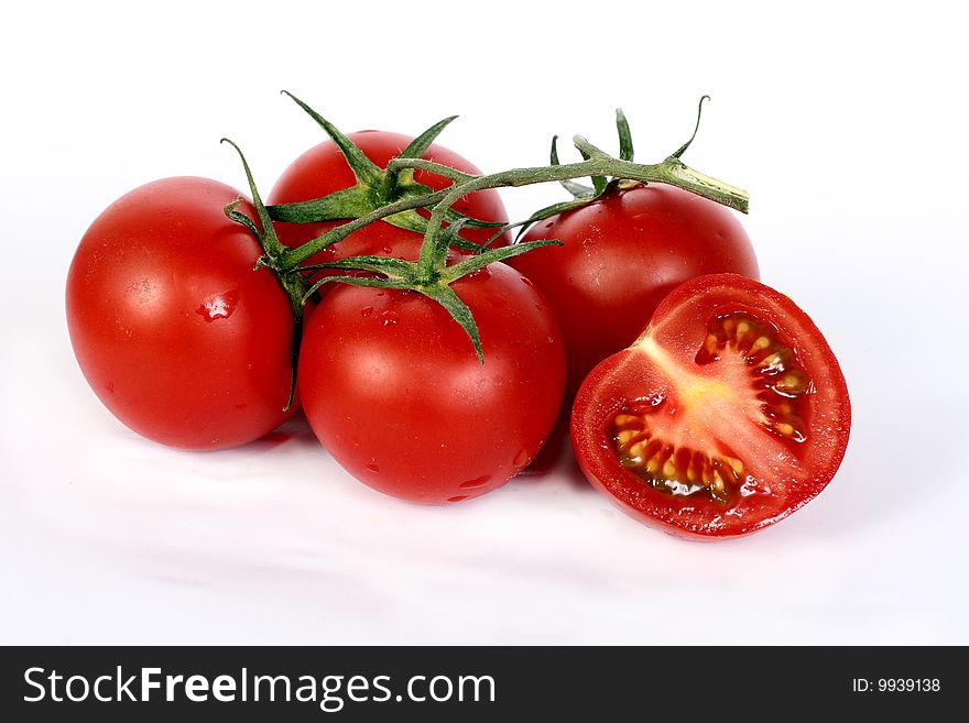 Some juicy red tomatoes on a white background. Some juicy red tomatoes on a white background