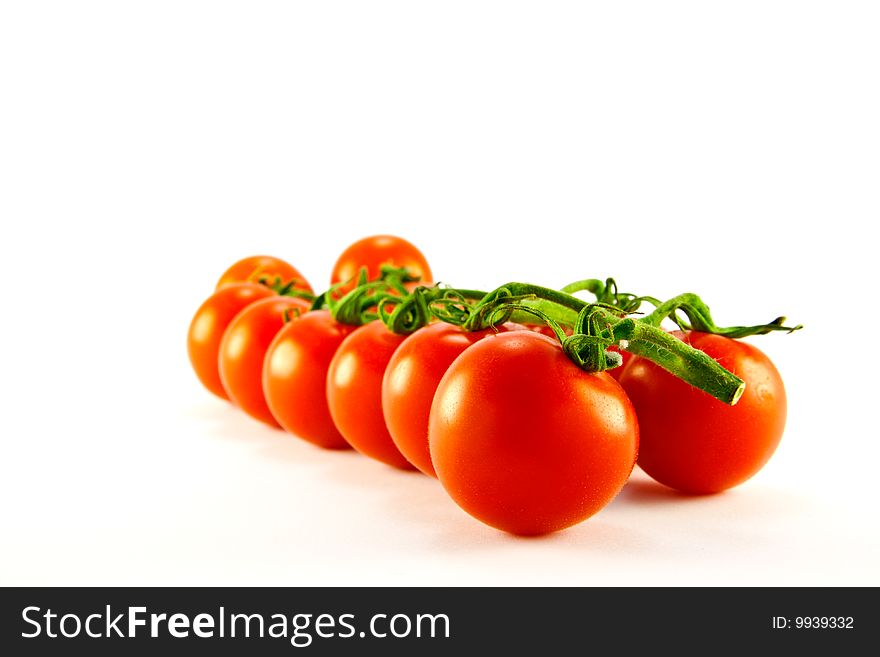 Cherry tomatoes on the vine with clipping path on a white background