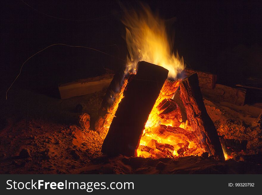 Hot fireplace full of wood and fire burning, bonfire at the camp