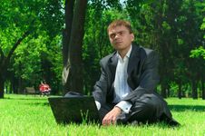 Businessman In A Park On The Grass Wiht Laptop Royalty Free Stock Photos Businessman In A Park On The Grass Wiht Laptop Royalty Free Stock Photos