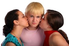Two Girls And Young Man Kisses Royalty Free Stock Photography