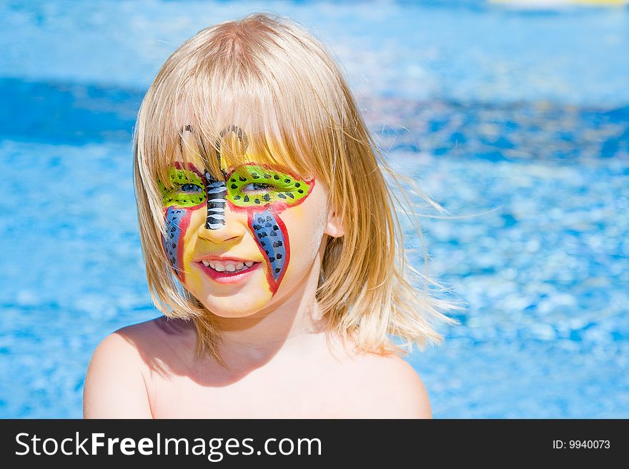 Girl with paint on his face in the pool. Girl with paint on his face in the pool