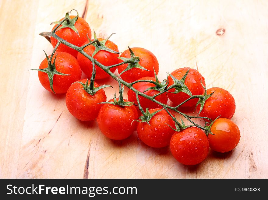 Cherry tomatoes on wooden cutting board