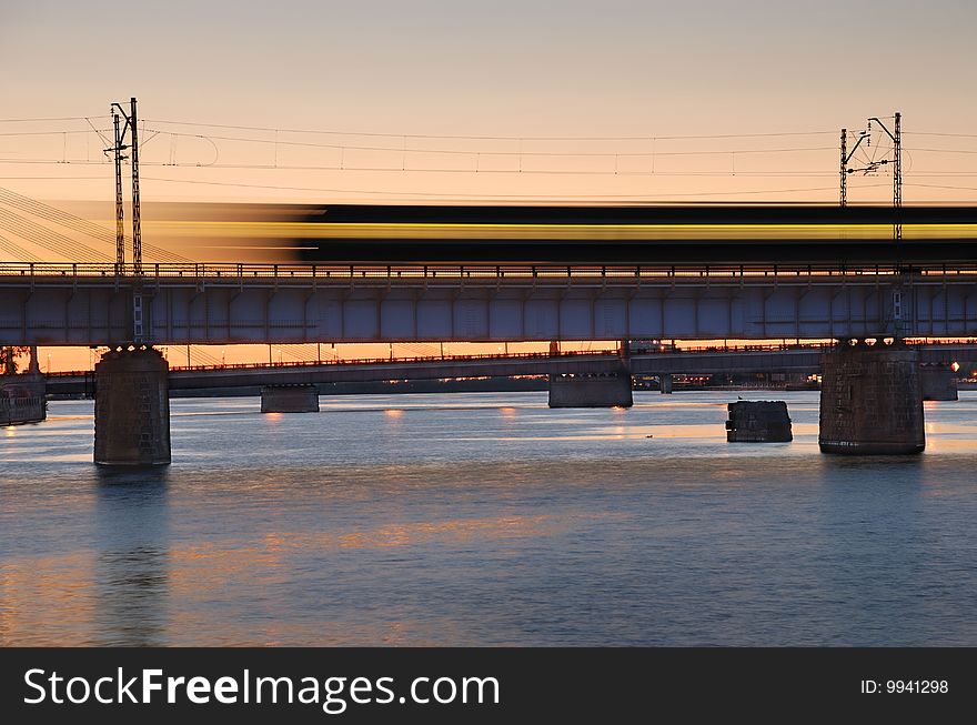 The morning express train on the bridge across Daugava river.