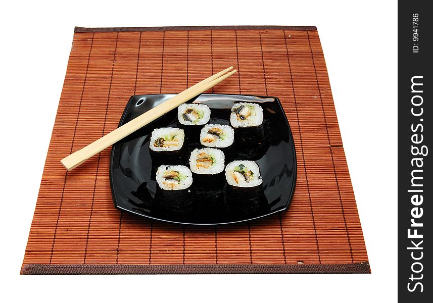 Sushi over bamboo mat and chopsticks