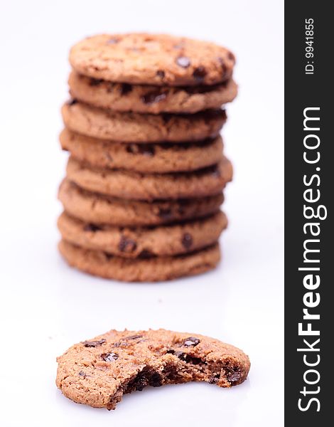 Chocolate chip cookies with bite missing isolated on white background