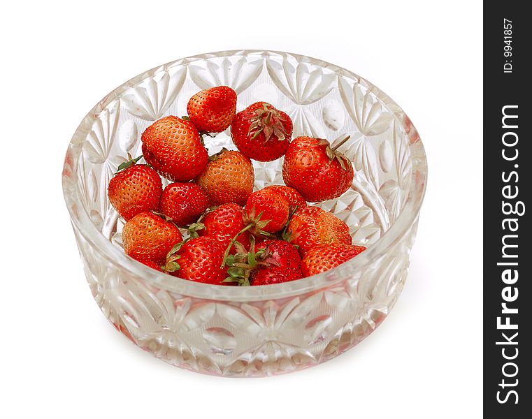 Glass bowl full of strawberries isolated on white bg. Glass bowl full of strawberries isolated on white bg