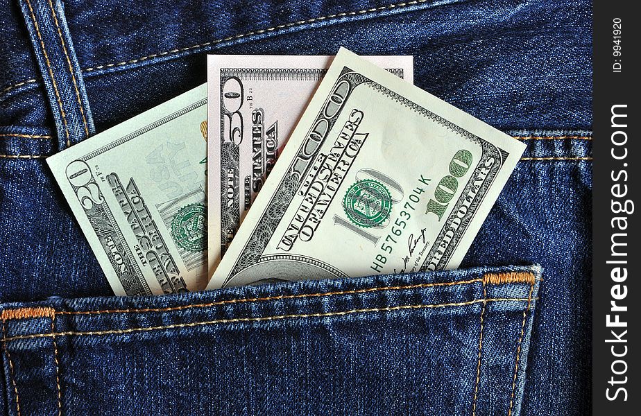 A lot of USD in the pocket of denim trousers. A lot of USD in the pocket of denim trousers.