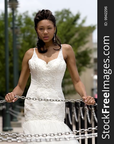 Great looking model in formal dress, posed with chains. Great looking model in formal dress, posed with chains.