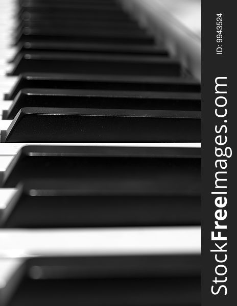 Keyboard of a grand piano: focus on a keys on the center