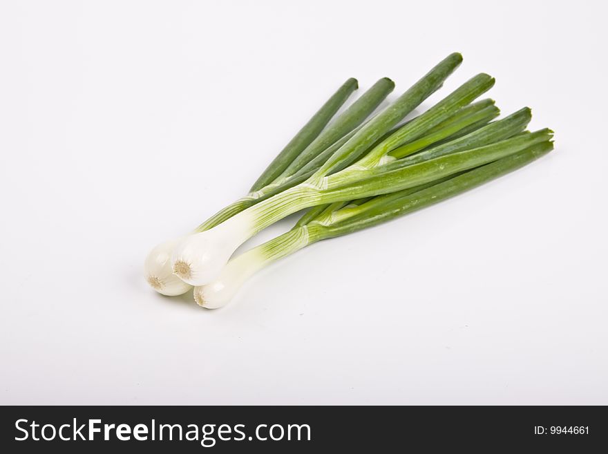 Fresh spring onions isolated over white background