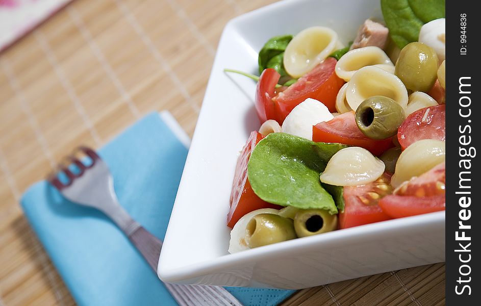 Healthy pasta with olives mozzarella and tomatoes