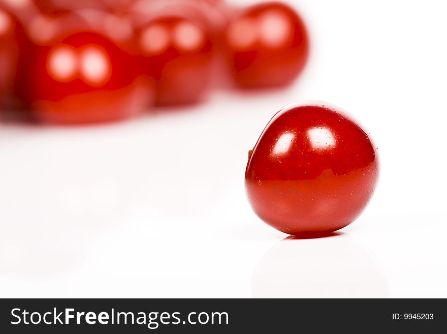 Red fresh sour cherries on white background