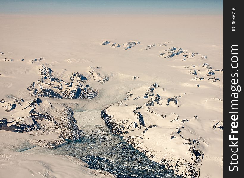 Aerial view of Glacier and Ice Floe taken at 39000 feet over Greenland. Aerial view of Glacier and Ice Floe taken at 39000 feet over Greenland.