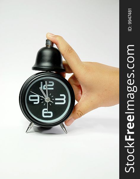 Hand With Black Alarm Clock