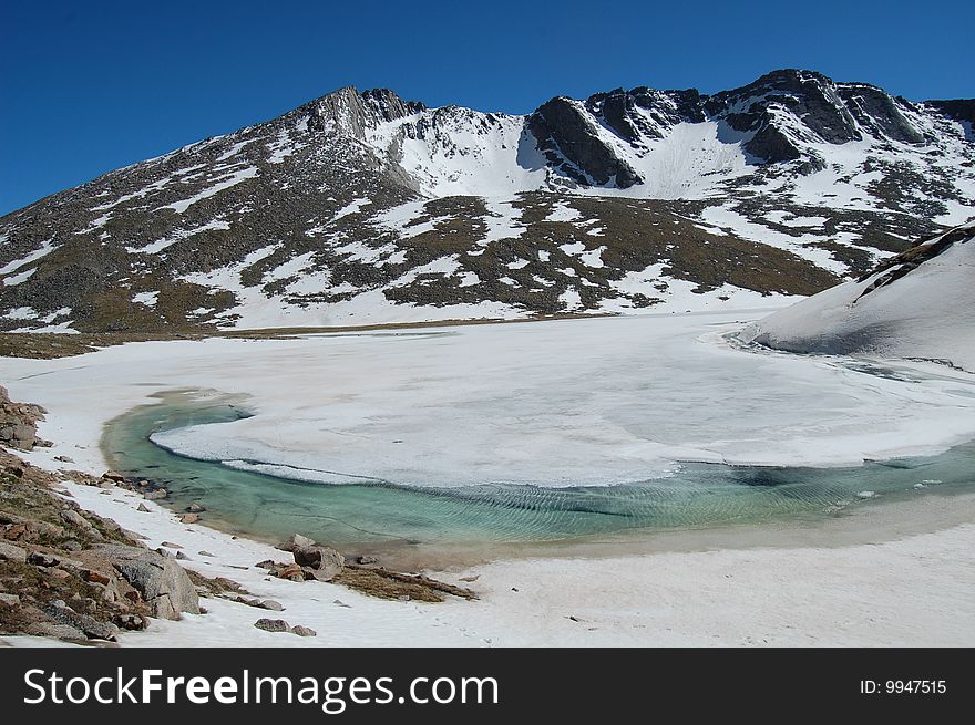 View of an icy lake in the Mt. Evan's alpine zone. View of an icy lake in the Mt. Evan's alpine zone.