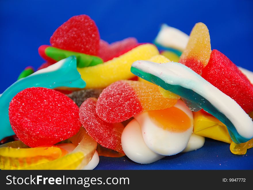 Close-up of an assortment of candies on a blue background. Close-up of an assortment of candies on a blue background