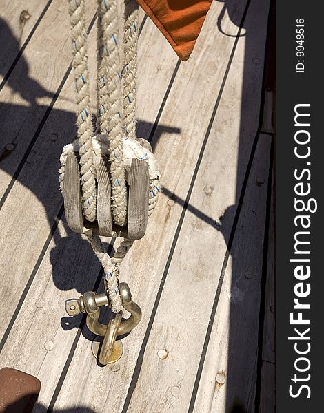 Rigging set. Knots, sheaves, pulleys, swivels, shackles, thimbles, strings and cables, in a vintage wooden sailing ship. Rigging set. Knots, sheaves, pulleys, swivels, shackles, thimbles, strings and cables, in a vintage wooden sailing ship