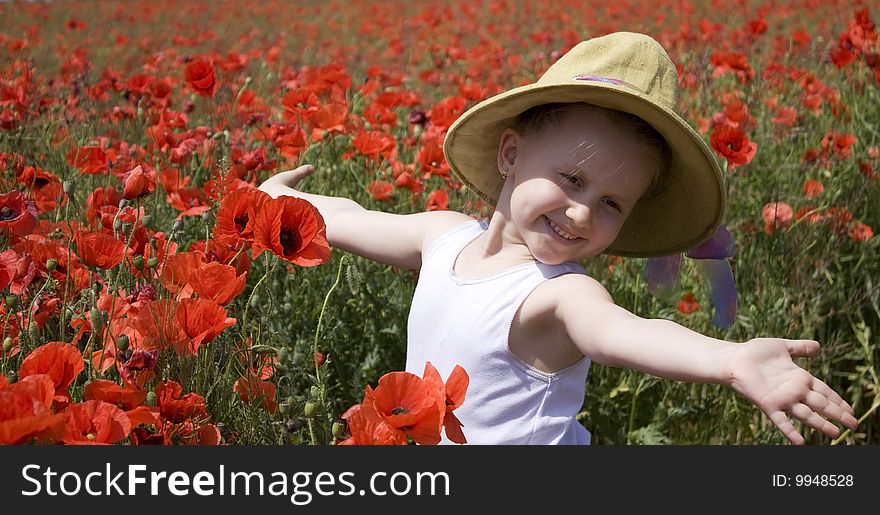 On the image there is a little girl. She is in field of flowers. On the image there is a little girl. She is in field of flowers.